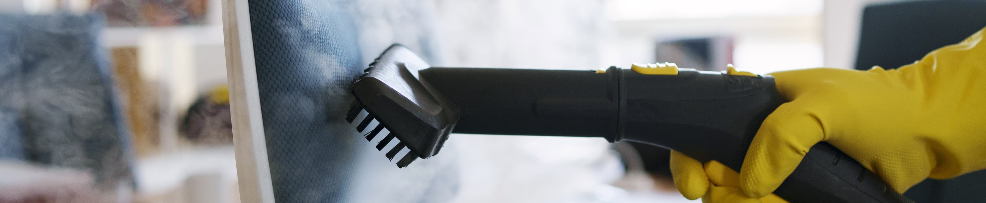 Professional cleaning service person using steam cleaner office